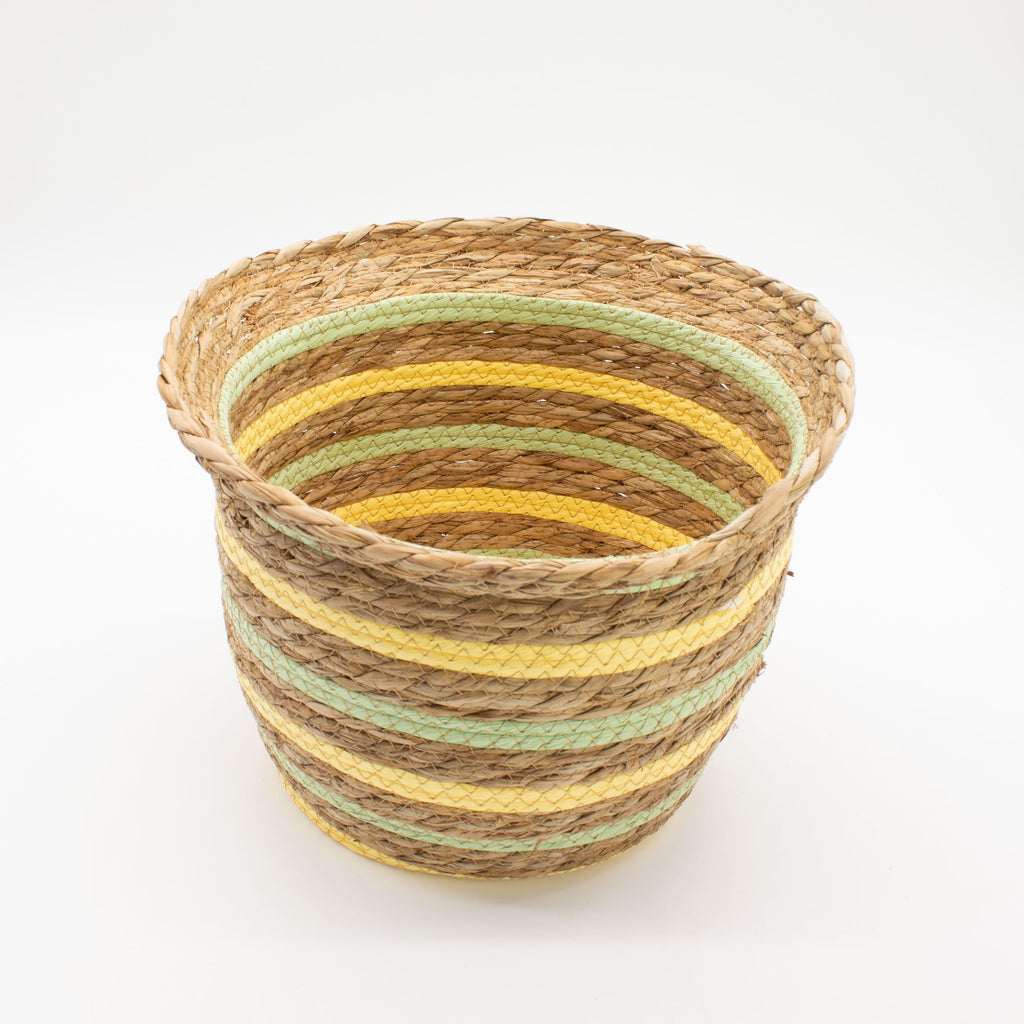 Woven basket with striped pattern on a white background