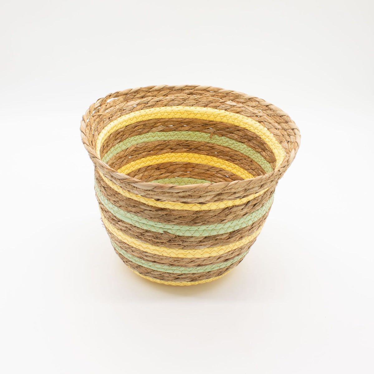 Woven basket with yellow and green stripes on a white background