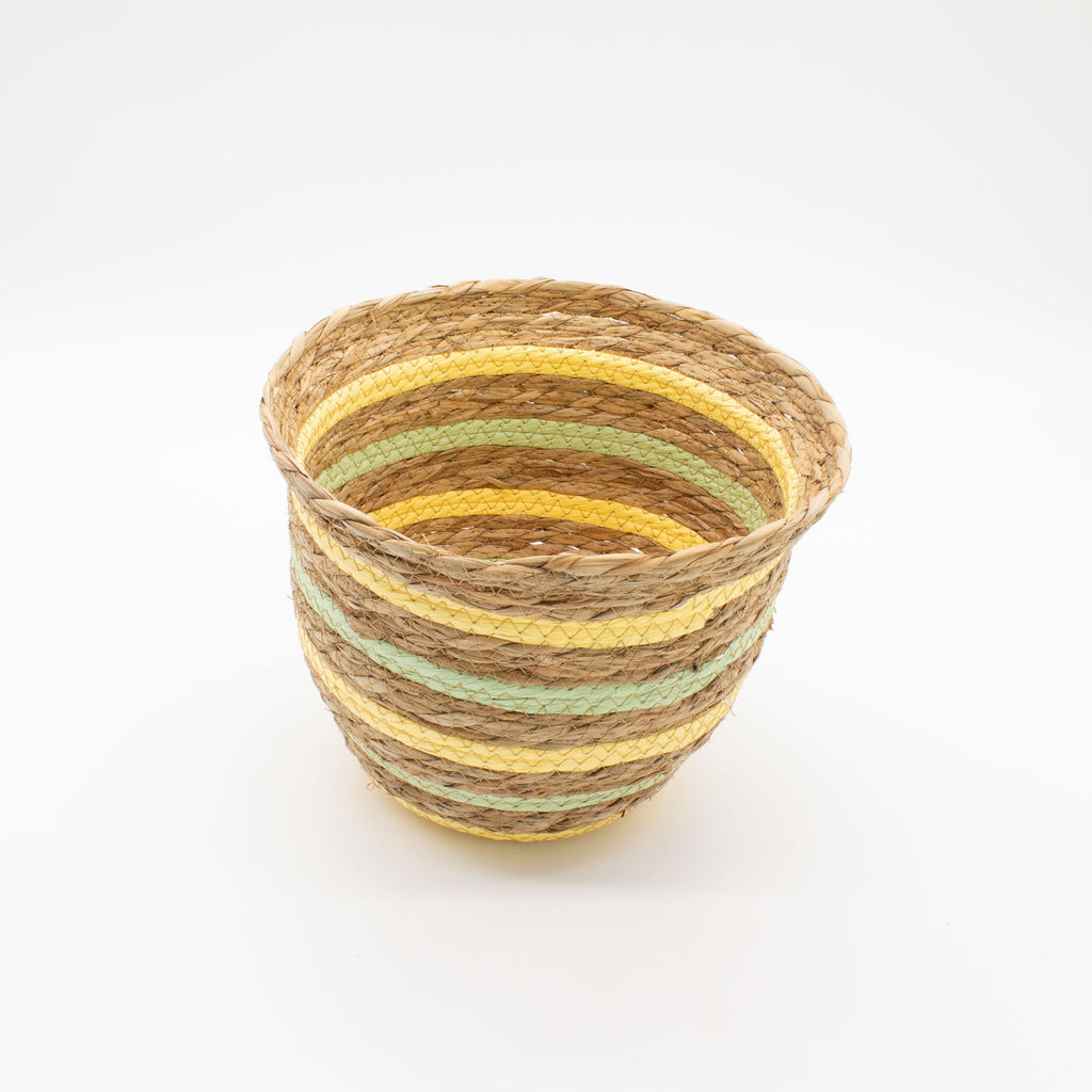 Woven basket with striped pattern on a white background