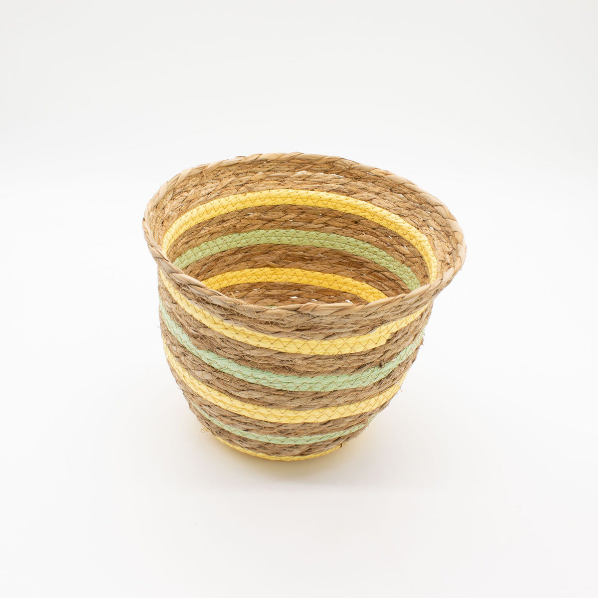 Woven basket with striped pattern on a white background
