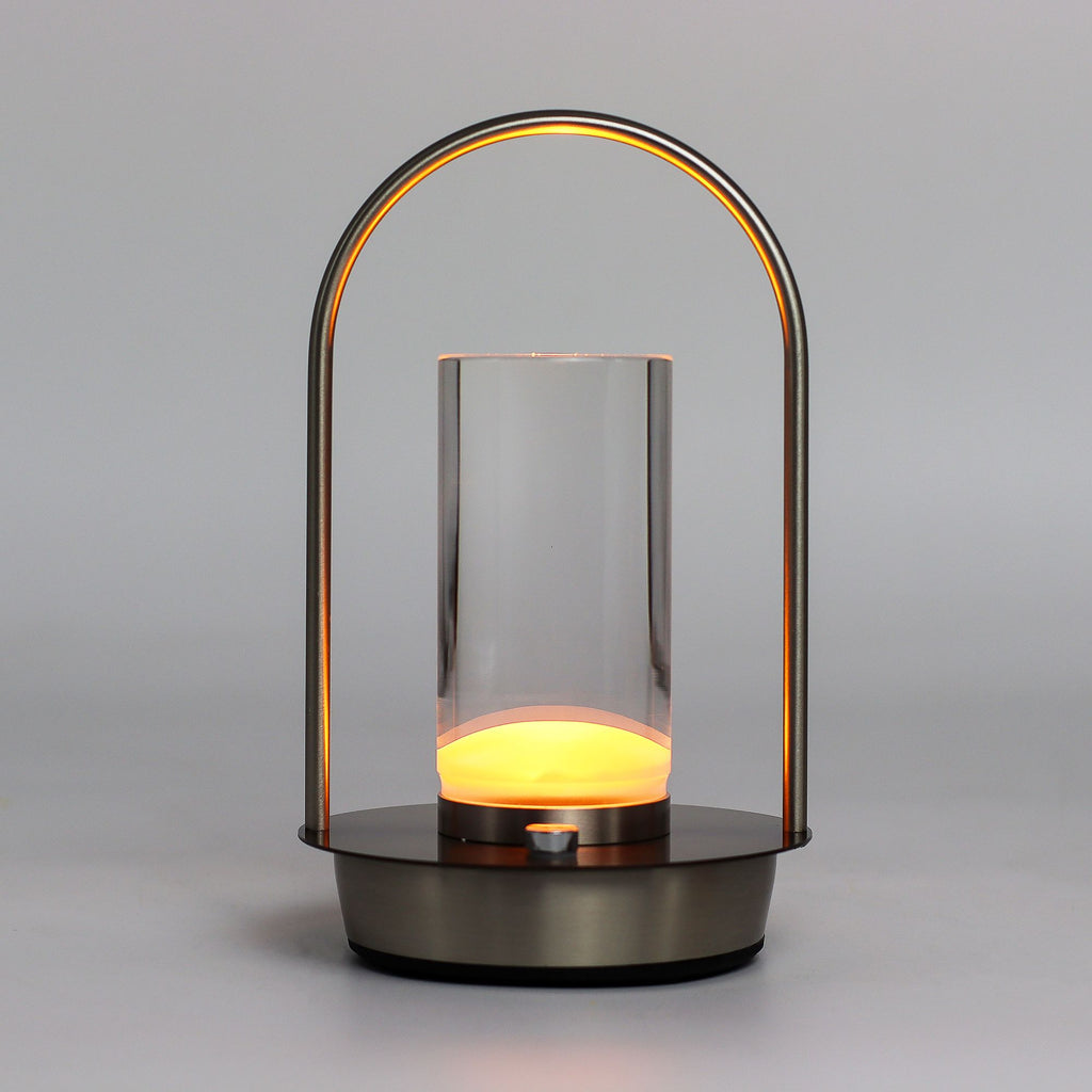 Modern lantern-style lamp with glass cover and glowing interior on a gray background