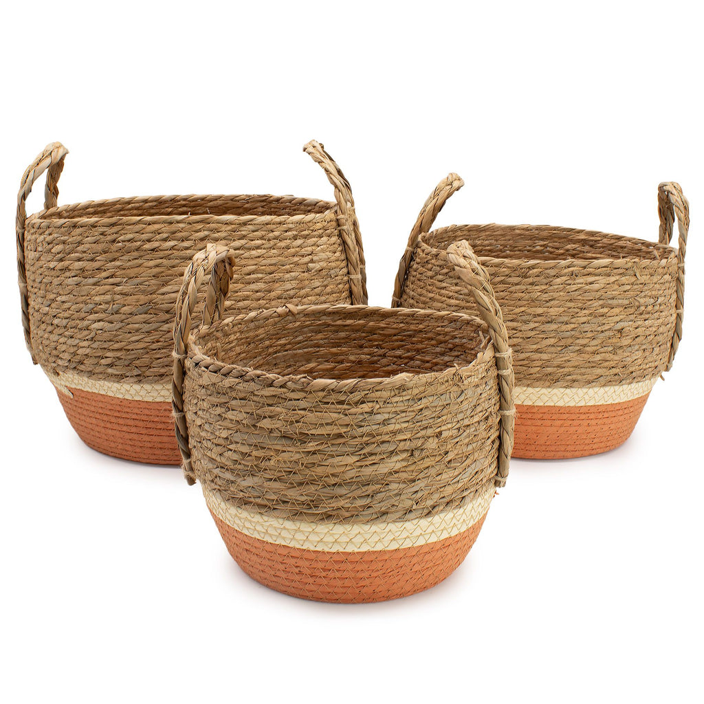 Three woven baskets with handles on a white background