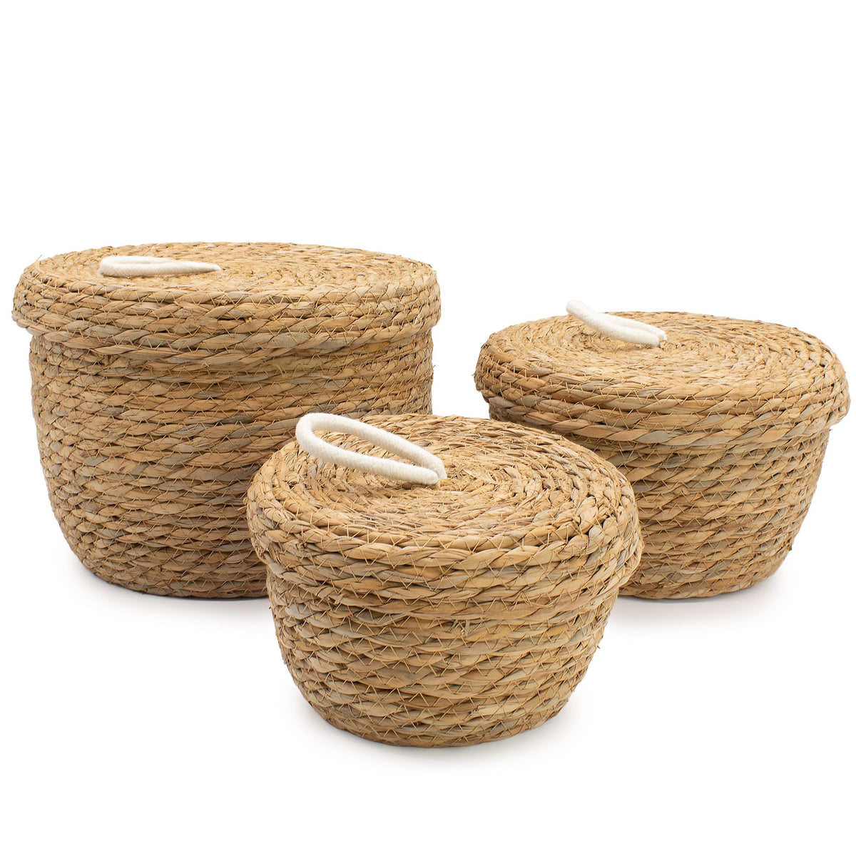 Three woven baskets with lids on a white background
