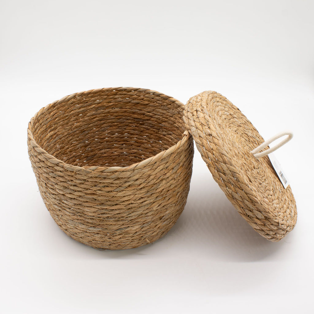 Woven basket with a lid on a white background