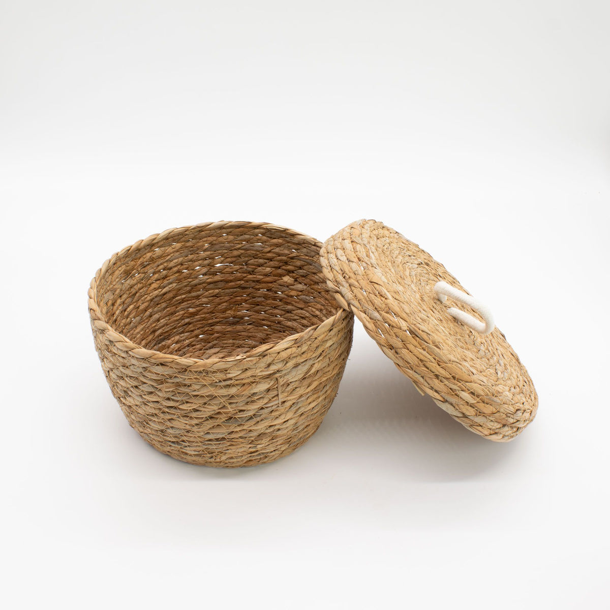 Woven basket with a lid on a white background