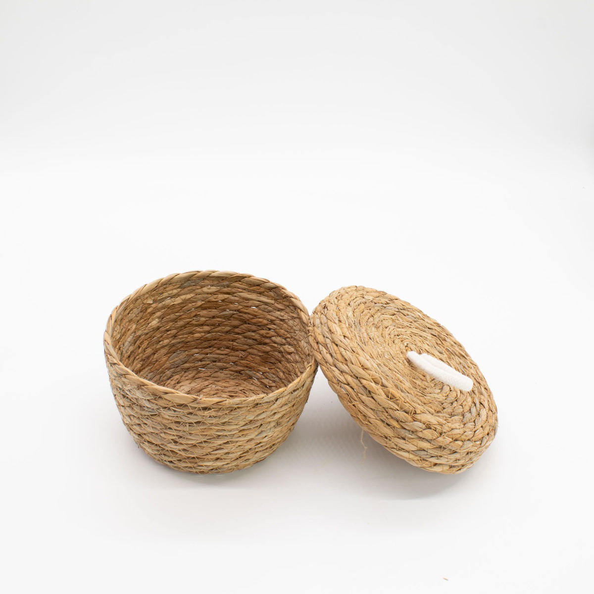 Woven basket with a lid on a white background