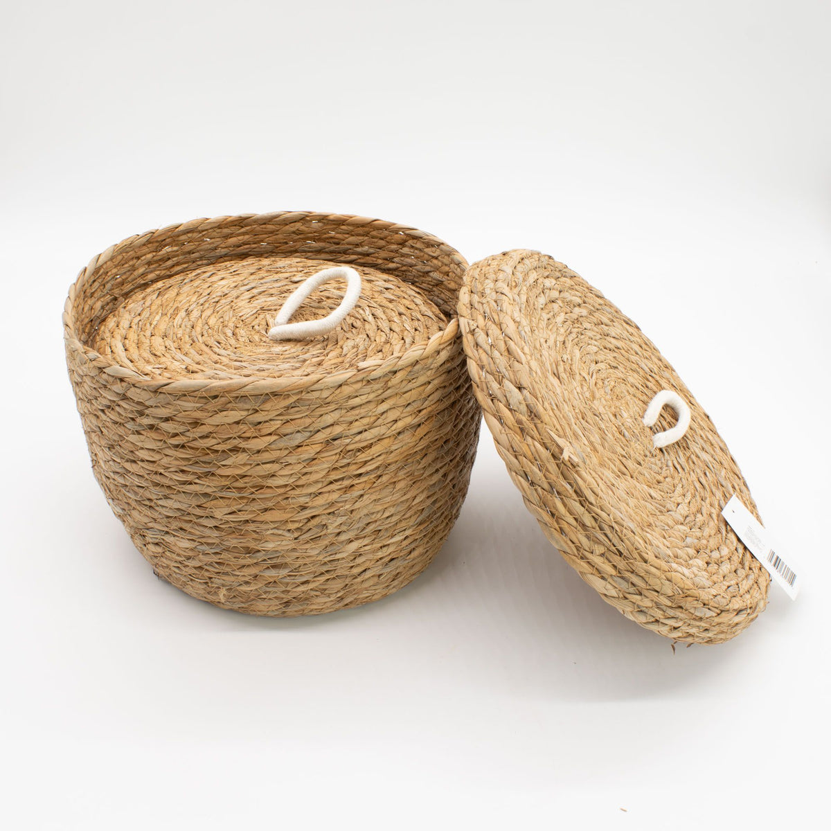 Woven basket with a lid on a white background