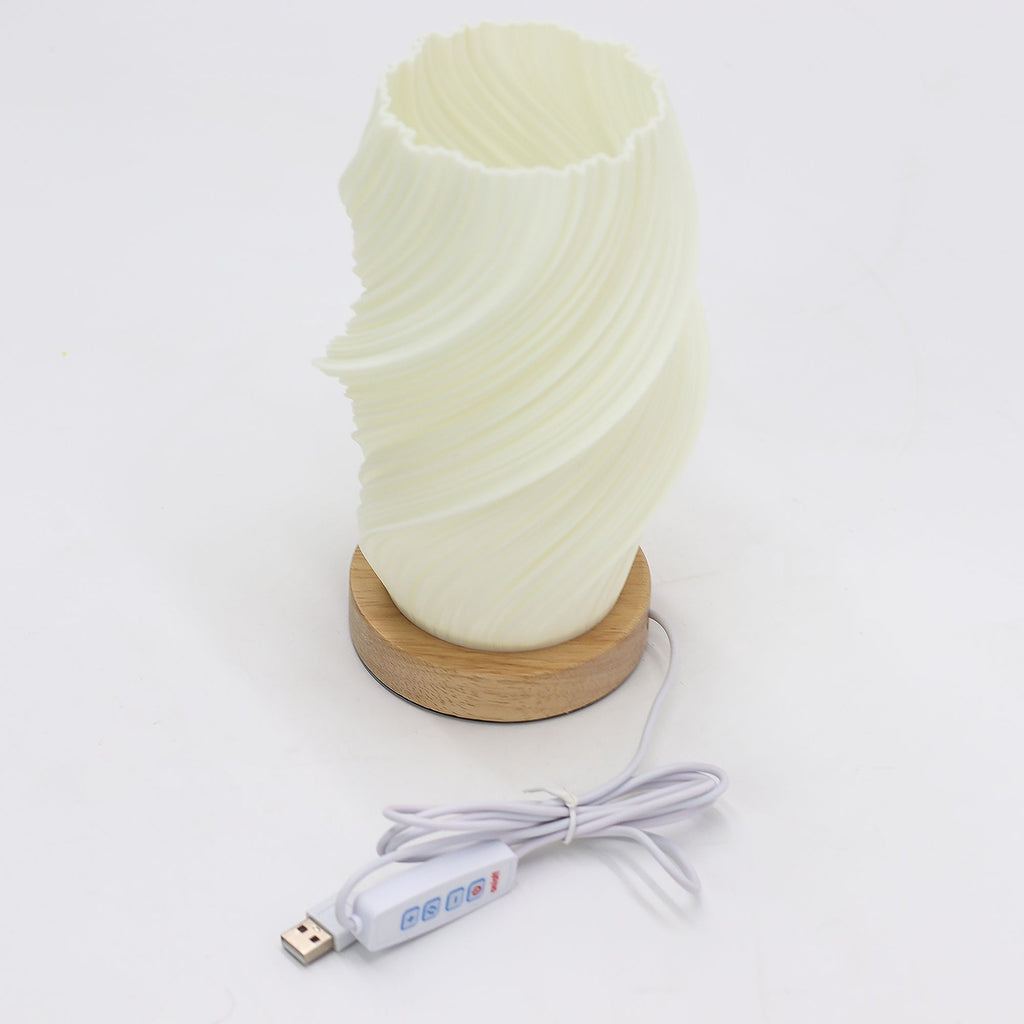 Cylindrical lamp with wavy texture and wooden base on a white background